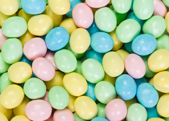 Fototapeta na wymiar Pastel colored candy eggs macro background