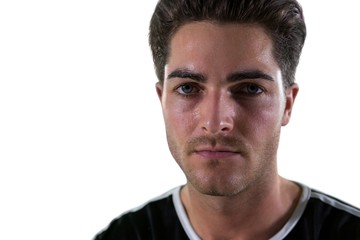 Obraz premium Portrait of football player standing against white background