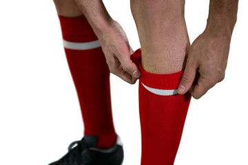 Football player pulling his socks up