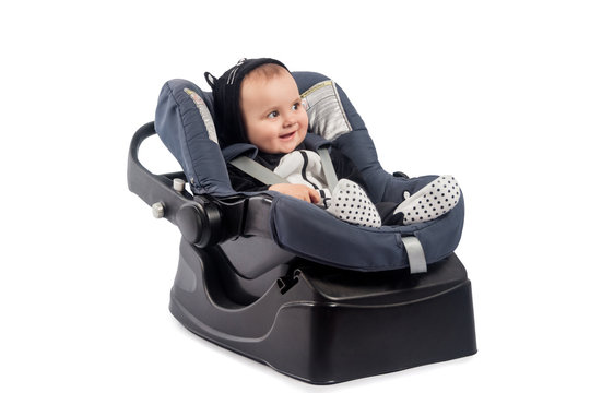 Smiling Infant Baby Child Sitting In A Car Seat, Isolated On White