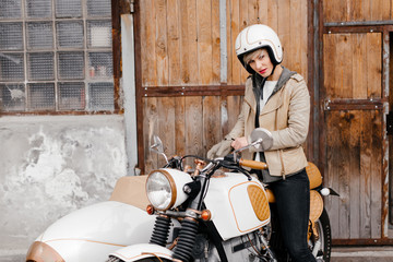 Fototapeta na wymiar Smiling girl on a motorcycle. Motorcycle . White motorcycle with a sidecar.