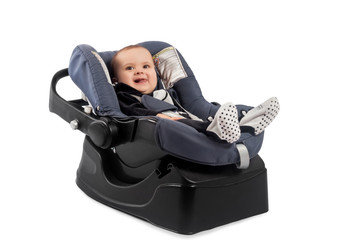 Smiling infant baby child sitting in a car seat, isolated on white