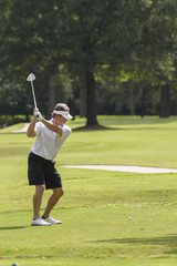Male golfer preparing to swing