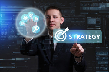 Business, Technology, Internet and network concept. Young businessman working on a virtual screen of the future and sees the inscription: Strategy