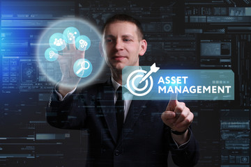 Business, Technology, Internet and network concept. Young businessman working on a virtual screen of the future and sees the inscription: Asset management