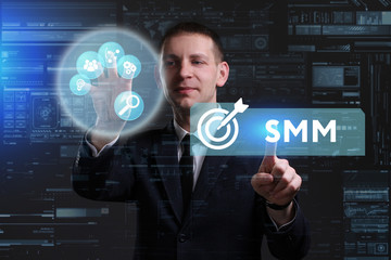 Business, Technology, Internet and network concept. Young businessman working on a virtual screen of the future and sees the inscription: SMM