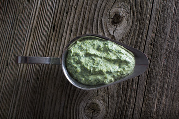 Homemade sauce with basil in white mortar