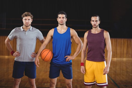 Male Basketball Players Standing In Basketball Court