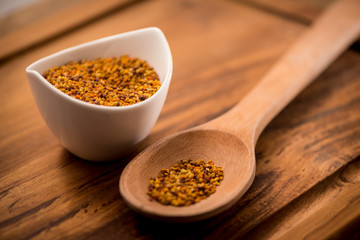 Bee Pollen in a bowl on a wooden surface