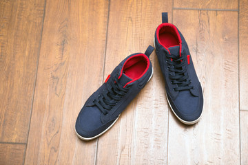 Blue sneakers on a wood background