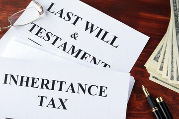 Inheritance tax form on a table and cash.