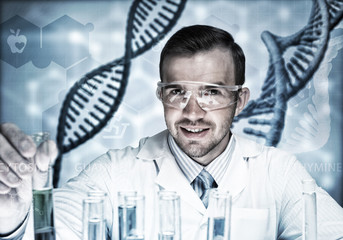 Young scientist mixing reagents in glass flask in clinical laboratory