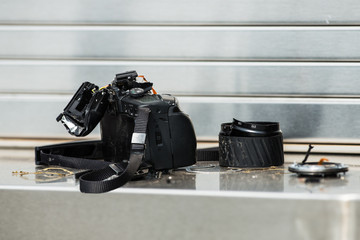 Broken camera equipment on a metal shelf
