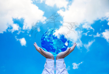 Planet and tree in human hands over blue sky with white clouds, Save the earth concept, Elements of this image furnished by NASA.