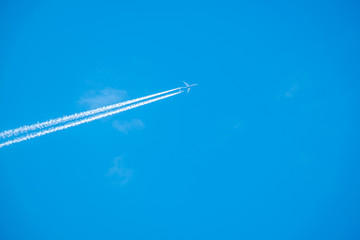 Trail of jet plane on blue sky