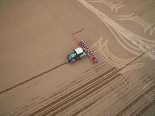 tractor - aerial view of a tractor at work cultivating a field in spring