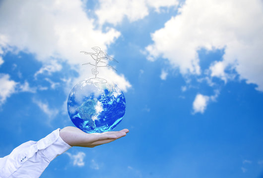 Planet and tree in human hands over blue sky with white clouds, Save the earth concept, Elements of this image furnished by NASA