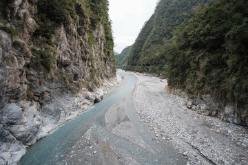 River flows through the mountains.