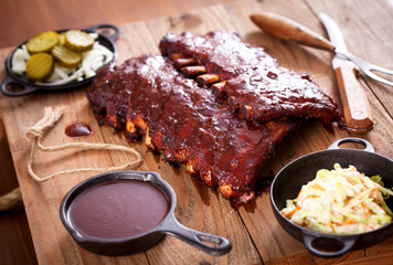 Smoked Barbecue Pork Spare Ribs with Sauce on a cutting board, selective focus