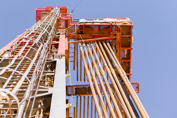 look up view for oil rig mast with drill pipe stands