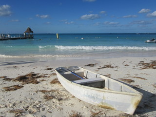 The white boat on white sand.