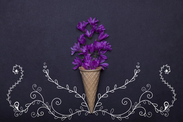 wafer or waffle ice cream cone and violet spring flowers