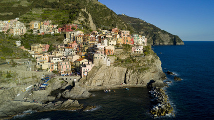 Fototapeta na wymiar Aerial video footage with drone on Manarola , one of the famous Cinqueterre country, small village with colored houses on the cliff over the sea