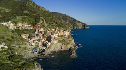 Fototapeta na wymiar Aerial video footage with drone on Manarola , one of the famous Cinqueterre country, small village with colored houses on the cliff over the sea
