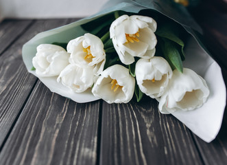 Mother's Day . white tulips on dark  wooden background