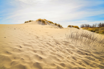 Moving colorful sand dunes in a sunny day
