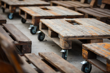 Wedding. Banquet. Decor. chill out area made of wooden storage pallets and soft pillows Decor of wooden pallets