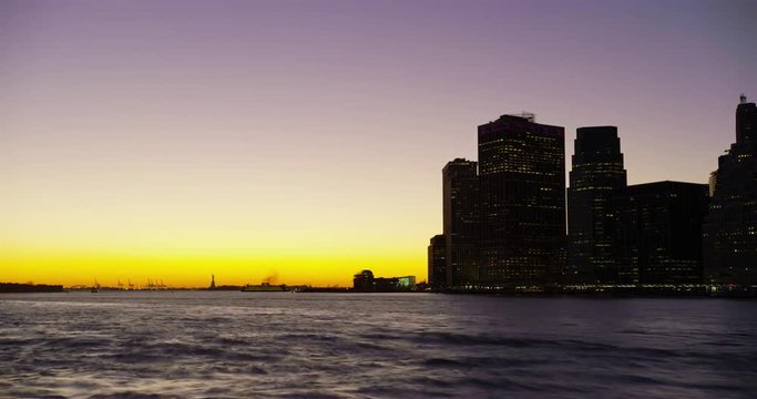 Time lapse of Manhattan Skyline with the Statue of Liberty in the distance.