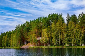 Wooden log cabin at the lake in summer in Finland