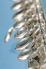 Macro shot of flute keys on blue with a shallow depth of field