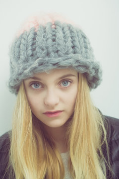 Pretty young girl with blond hair in fashionable hat