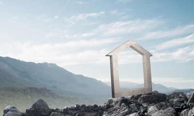 Conceptual image of concrete home sign on hill and natural landscape at background