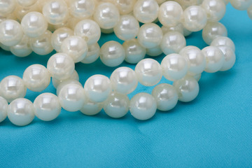 Bead necklace / View of plastic white bead necklace on fabric.