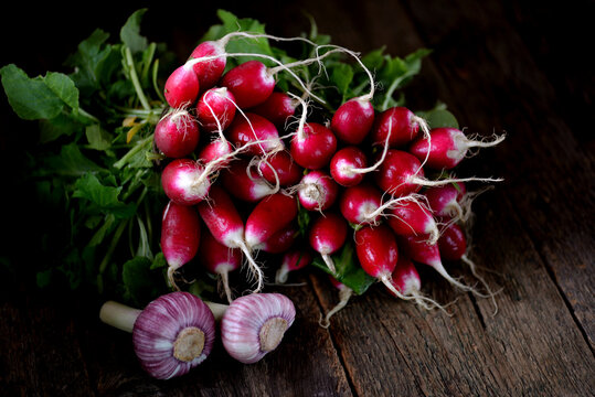 Fresh organic radish with green onions and garlic. Healthy food. Rustic style.