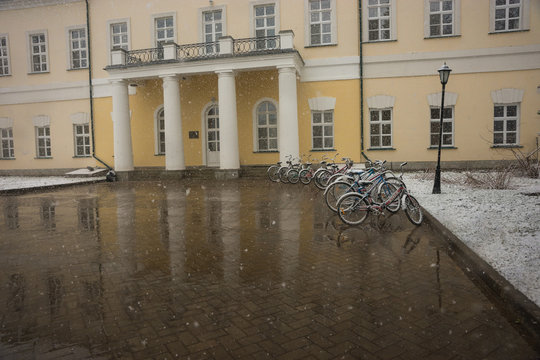 Bicycles smoothly covered with fresh snow after weather phenomena - snowfall in late April near Moscow