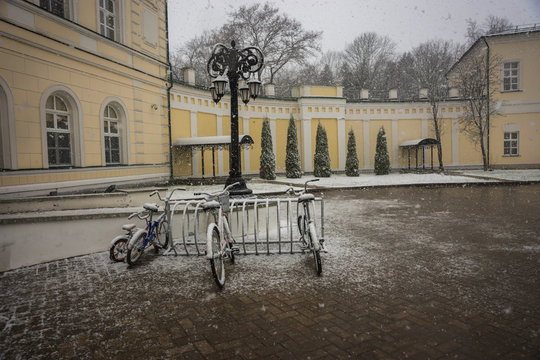 Bicycles covered with fresh snow after weather phenomena - snowfall in late April near Moscow