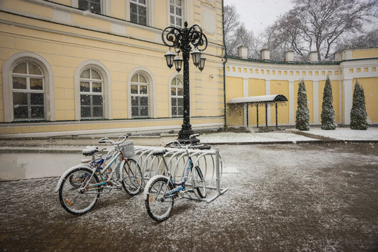 Bicycles covered with fresh snow after weather phenomena - snowfall in late April near Moscow