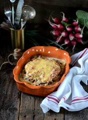 Chicken breast stuffed with mushrooms baked with potatoes under cheese.