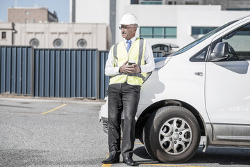 Engineer builder on construction site at sunny day with coffee i