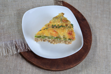 Meat vegetables pie and with cheese on a plate on a gray background