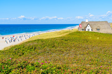 Typical Frisian house with straw roof on cliff at Kampen beach, Sylt island, Germany