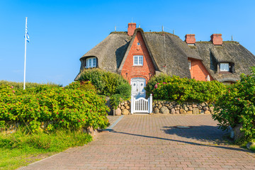 Typical frisian house with straw roof in Kampen village on Sylt island, Germany