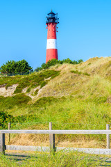 Fototapeta na wymiar Lighthouse on sand dune in Hornum village on southern coast of Sylt island, Germany