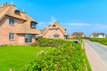 Typical Frisian red brick houses with straw roofs in Rantum village on southern coast of Sylt island, Germany
