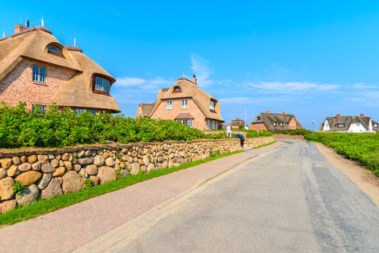 Typical Frisian red brick houses with straw roofs in Rantum village on southern coast of Sylt island, Germany