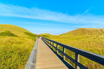 Wooden footbridge from sand dune to beautiful beach near Westerland village, Sylt island, Germany